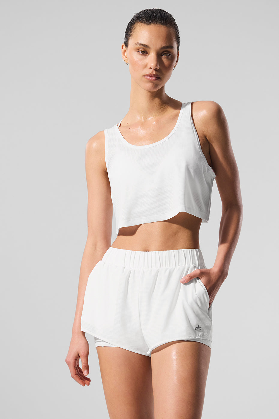 Men’s white cropped tank top laid flat for a clean view