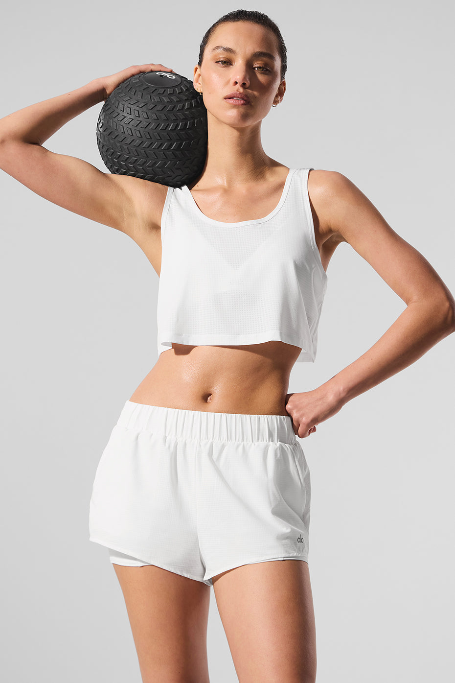 Men’s white cropped tank top laid flat for a clean view