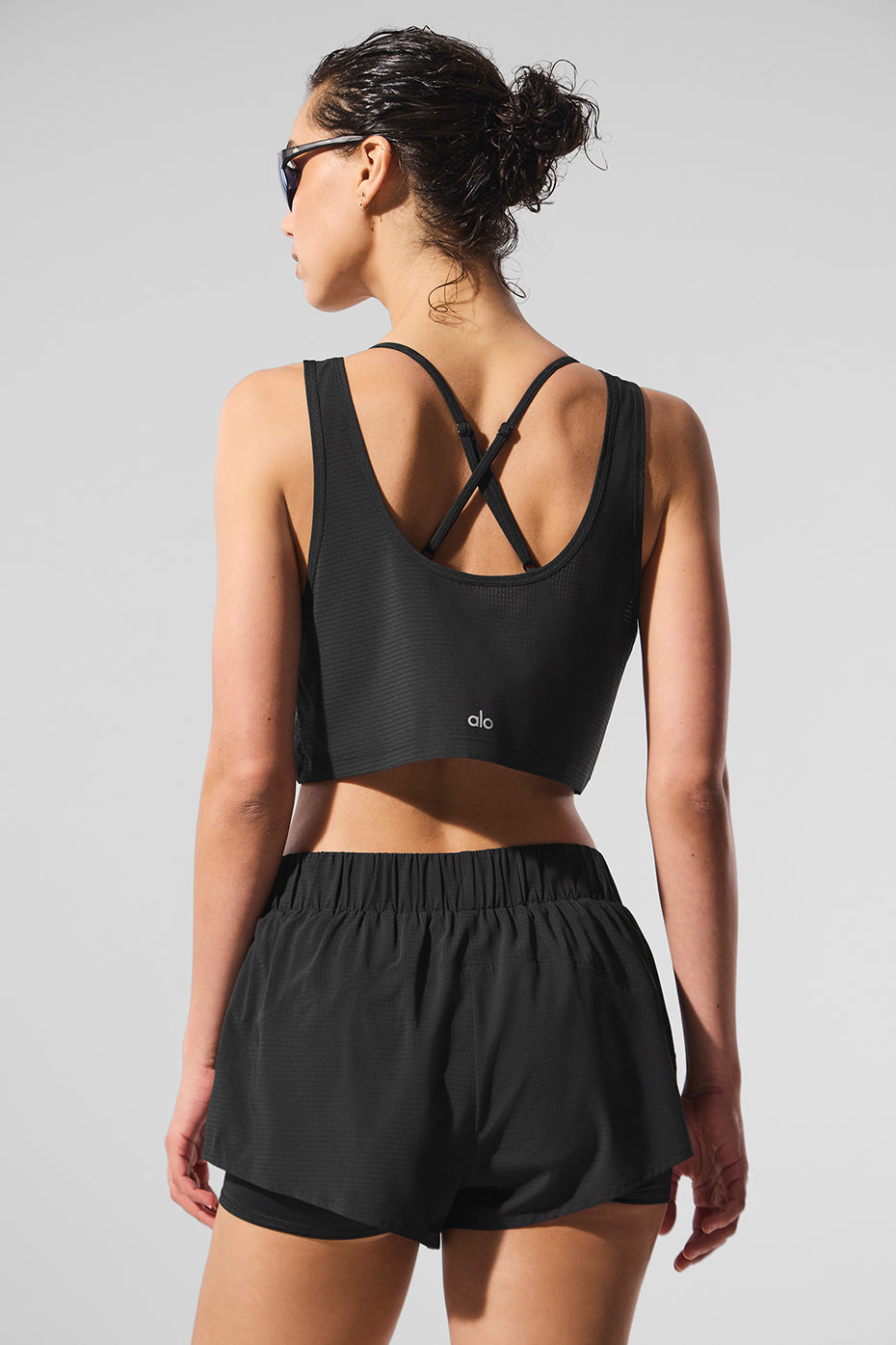 Casual styling of the sports bra tank top paired with workout leggings.