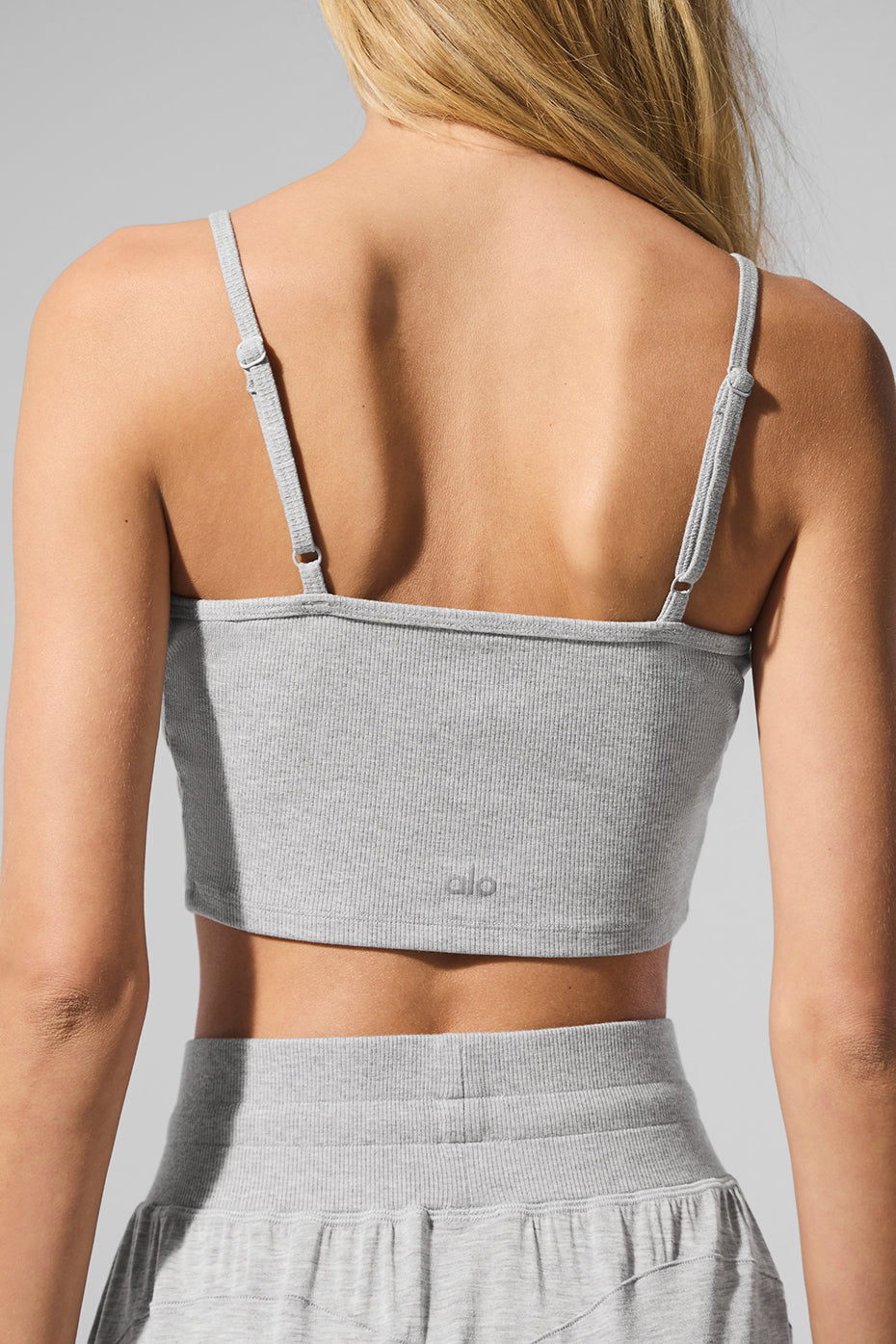 Model wearing the ribbed tank top paired with lounge pants.