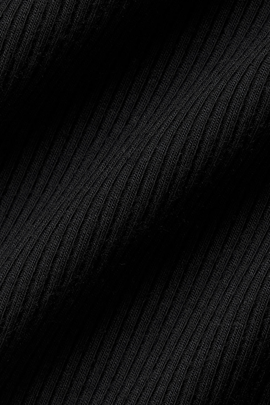 Close-up of ribbed modal texture on guys black tank top under natural light