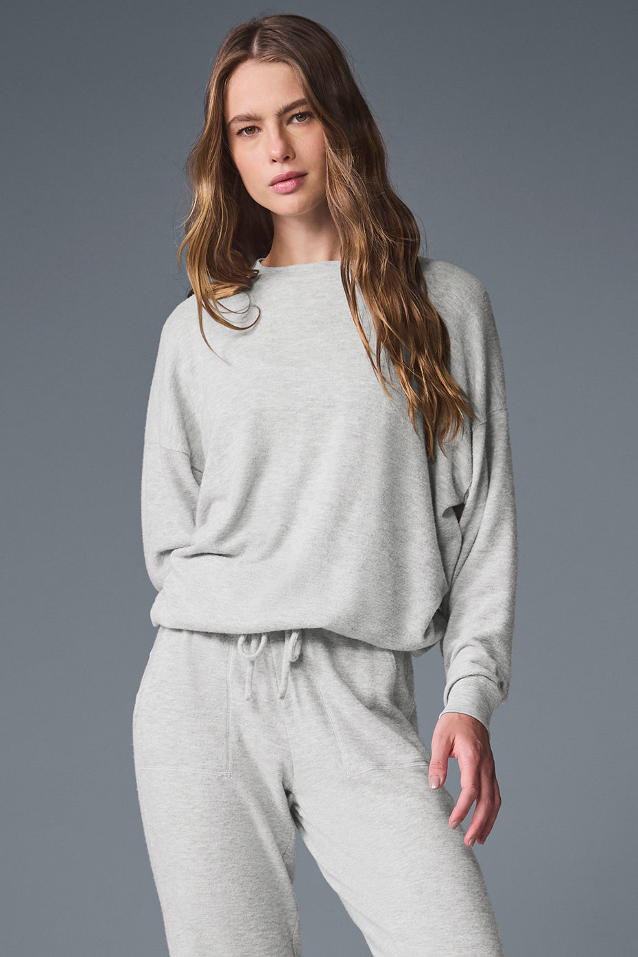 Model wearing the Soho studio pullover during a workout, emphasizing moisture-wicking material