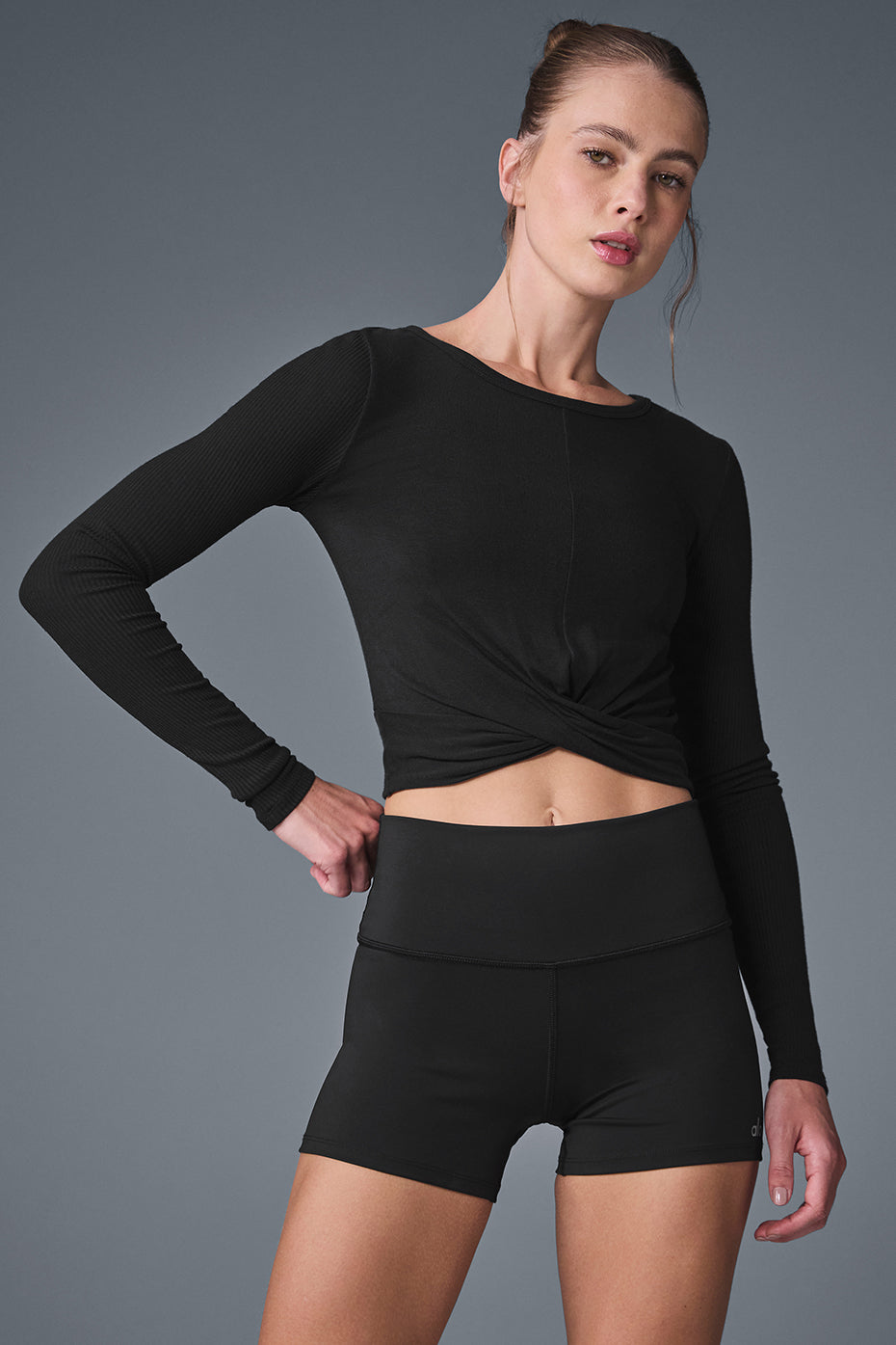 Front view of the black long sleeve crop top, showcasing its wrap design.