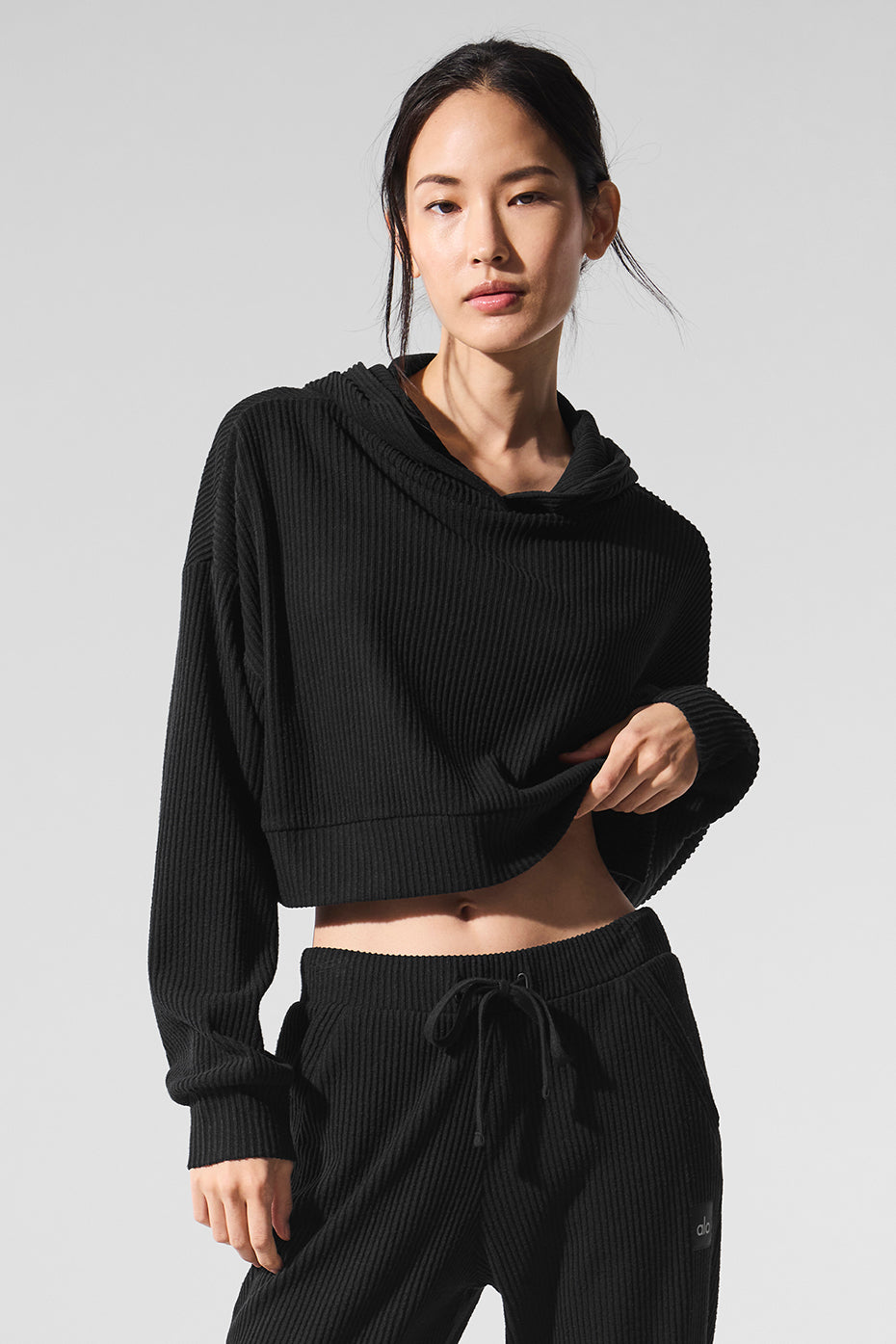 Close-up of the soft ribbed knit fabric of the Muse comfort hoodie in black