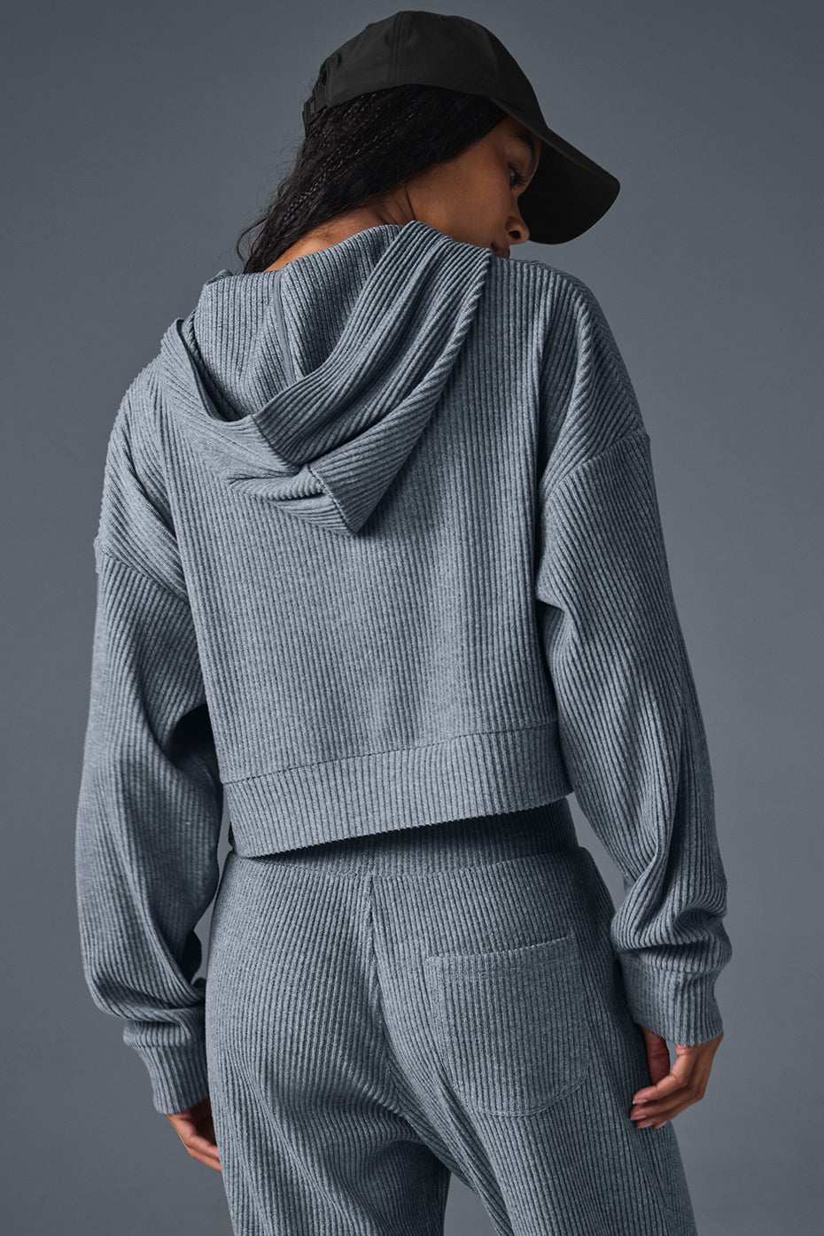 Side view of the cropped zip up hoodie, highlighting its relaxed silhouette.