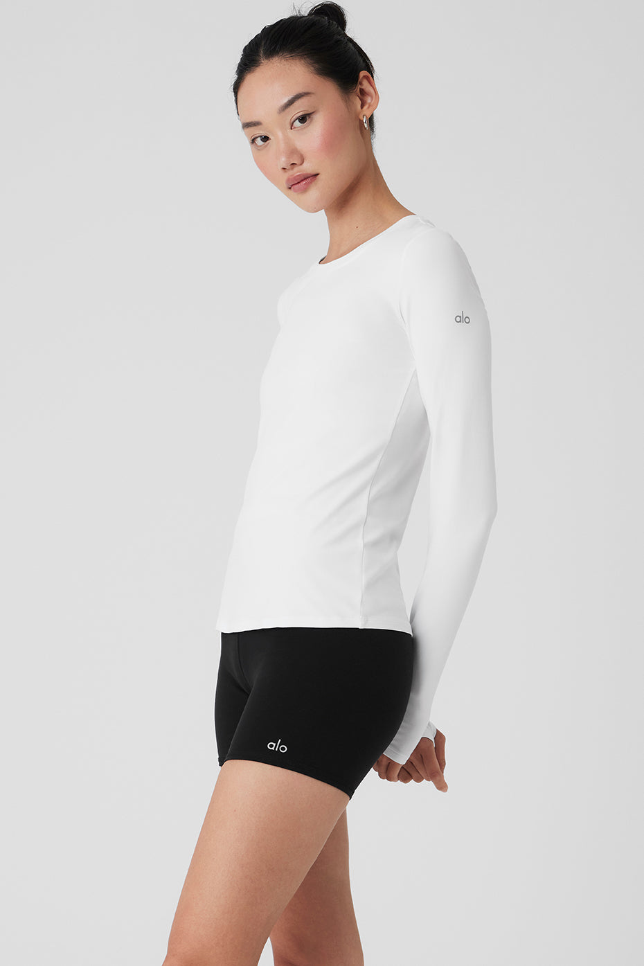 Model wearing Alosoft Finesse long sleeve shirt during a yoga session.