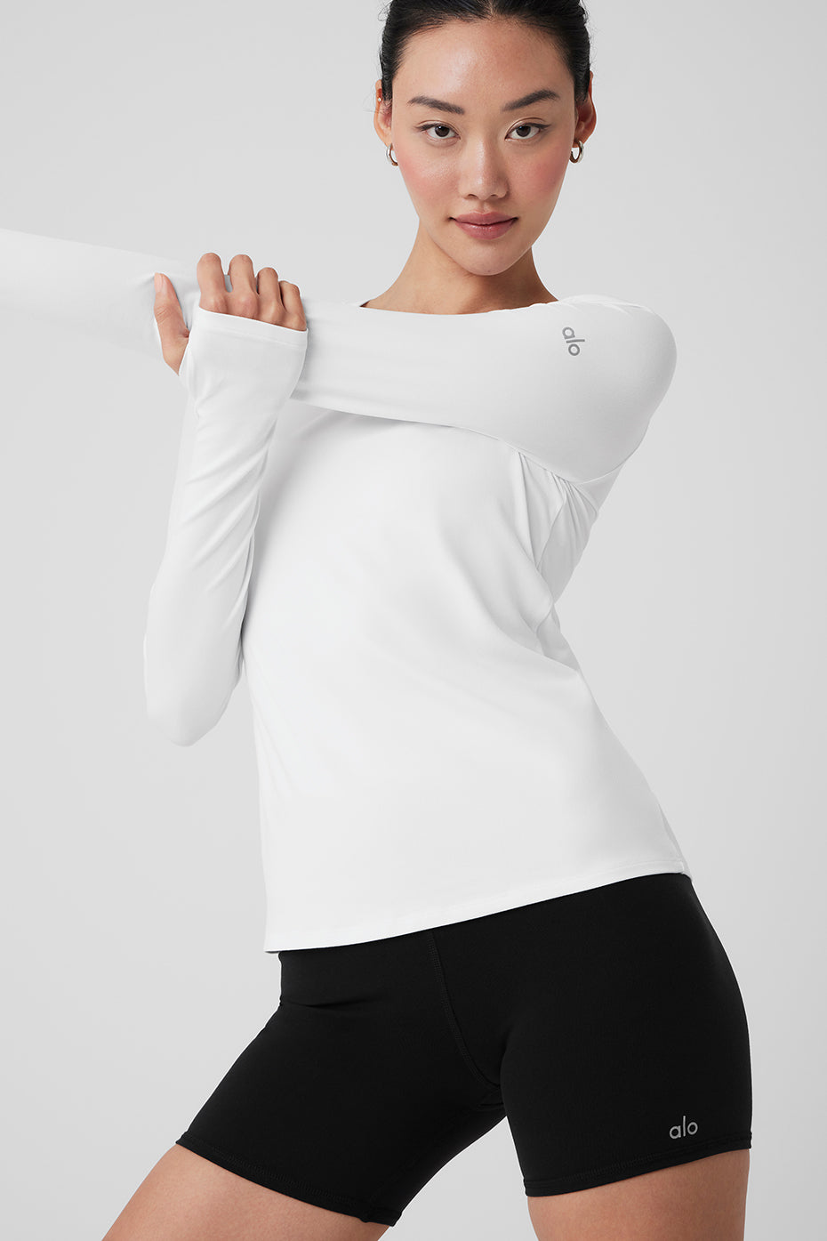 Front view of Alosoft Finesse long sleeve shirt in white, ideal for activewear.