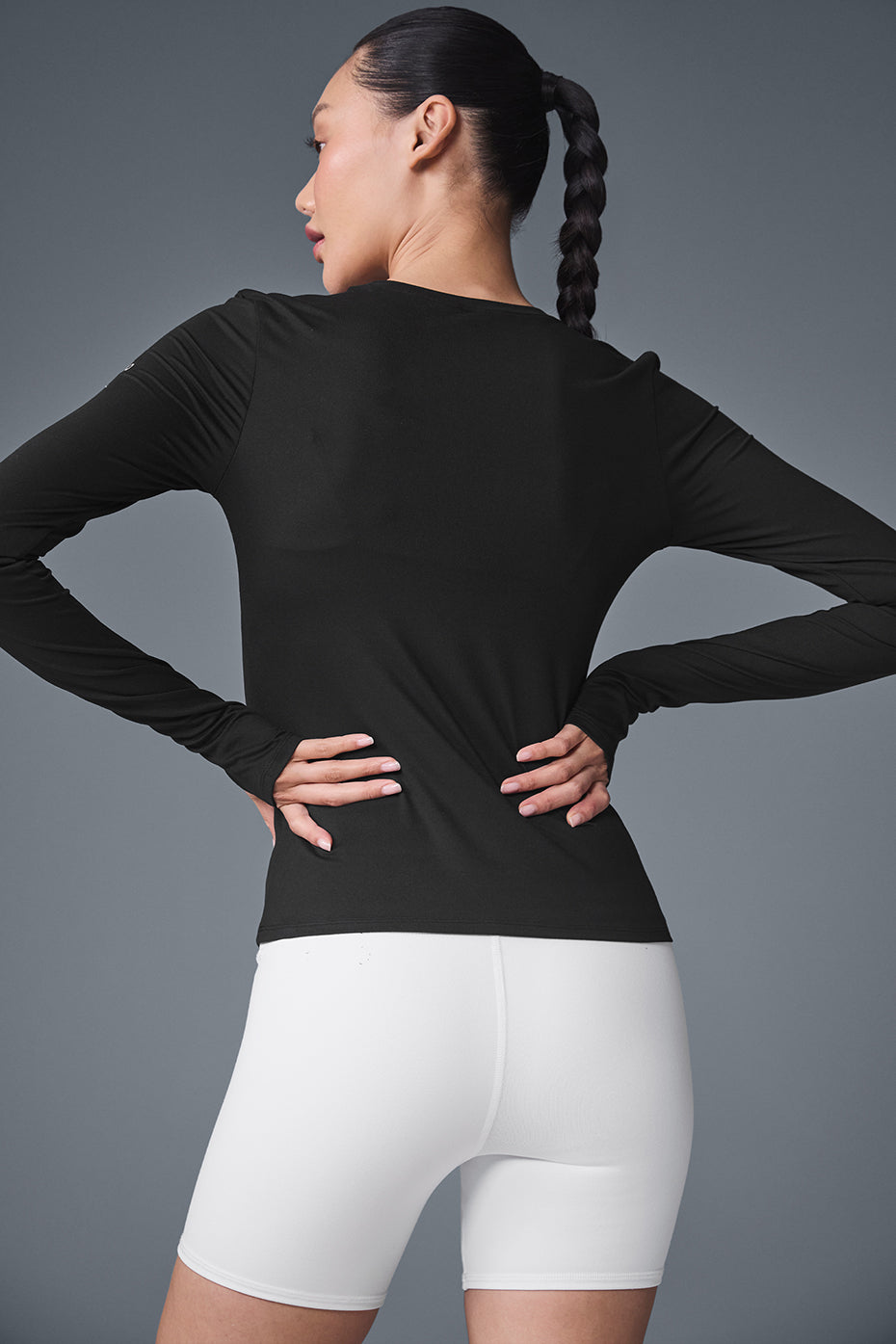 Model wearing Alosoft Finesse long sleeve t shirt with a stylish jacket