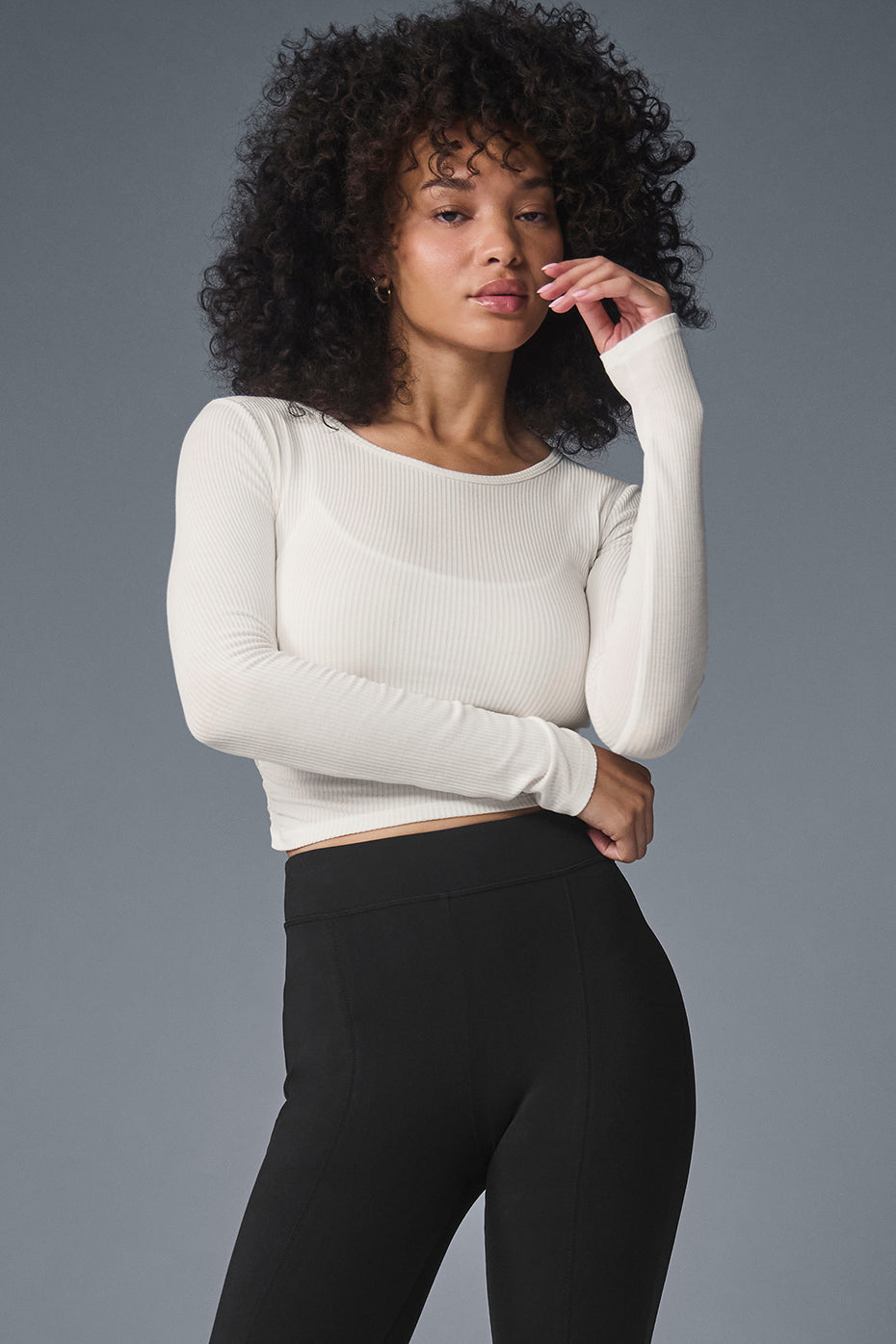 Front view of ivory long sleeve crop top with ribbed texture and cropped fit