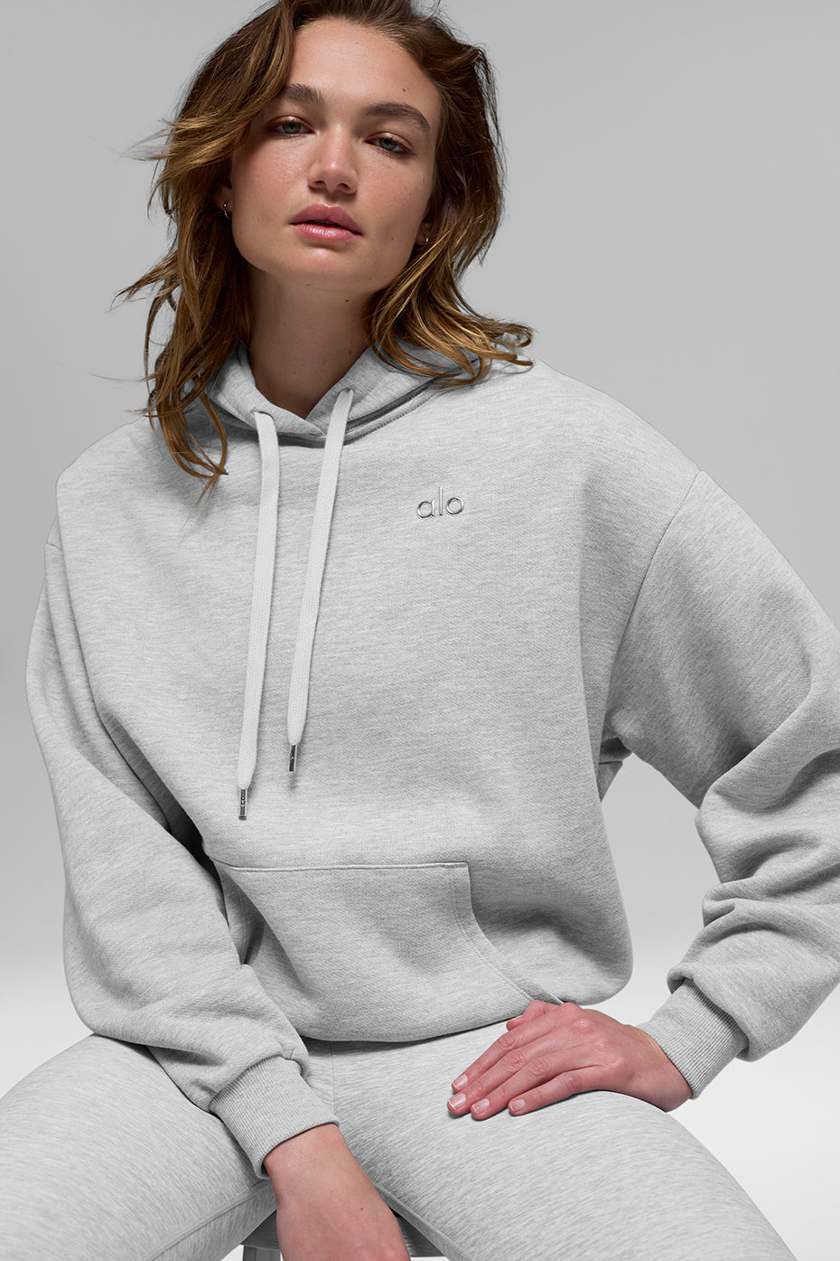 Front view of the Accolade hoodie in athletic Heather Grey showing its relaxed fit and kangaroo pocket