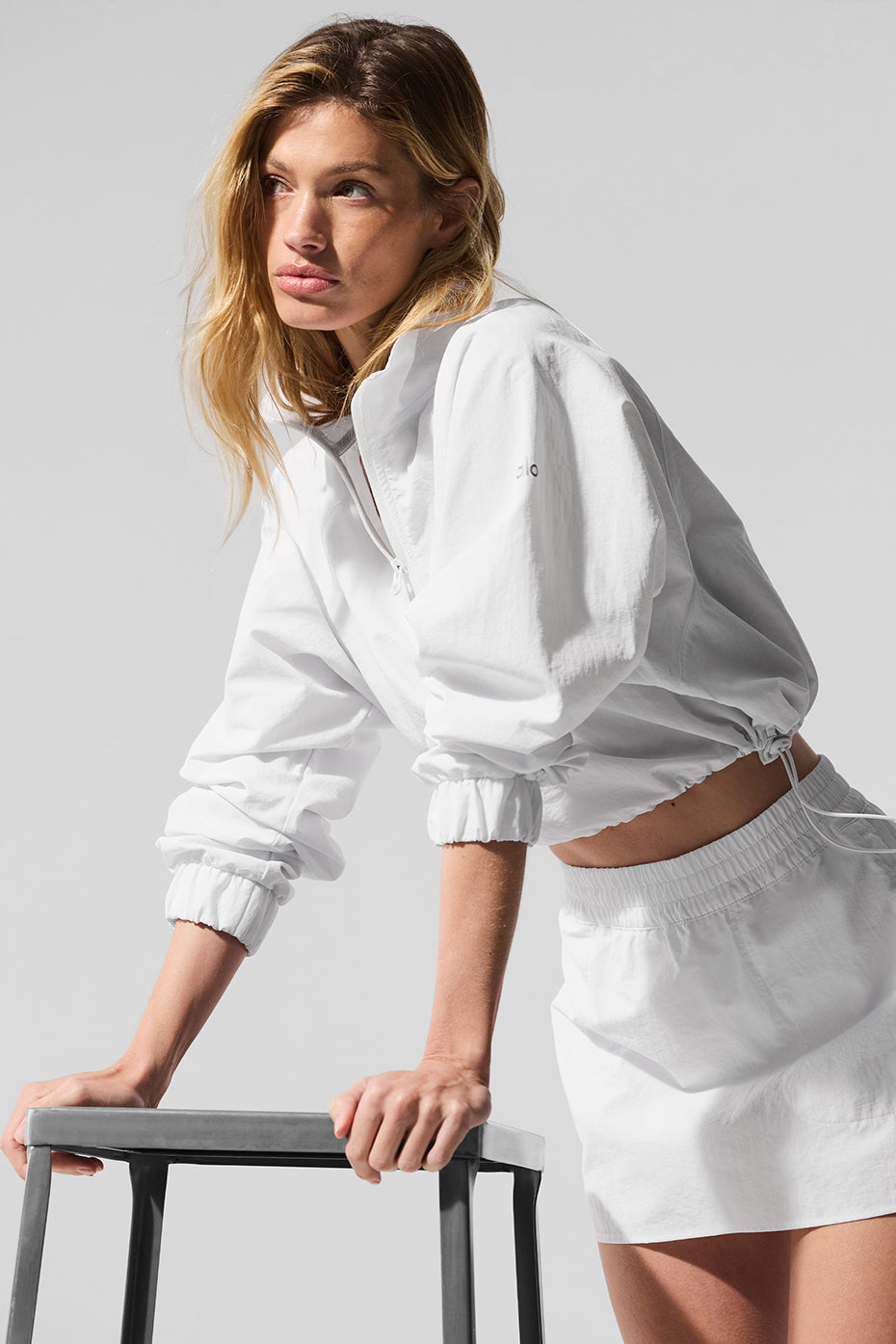 Model wearing the cropped pullover paired with leggings for a sporty look