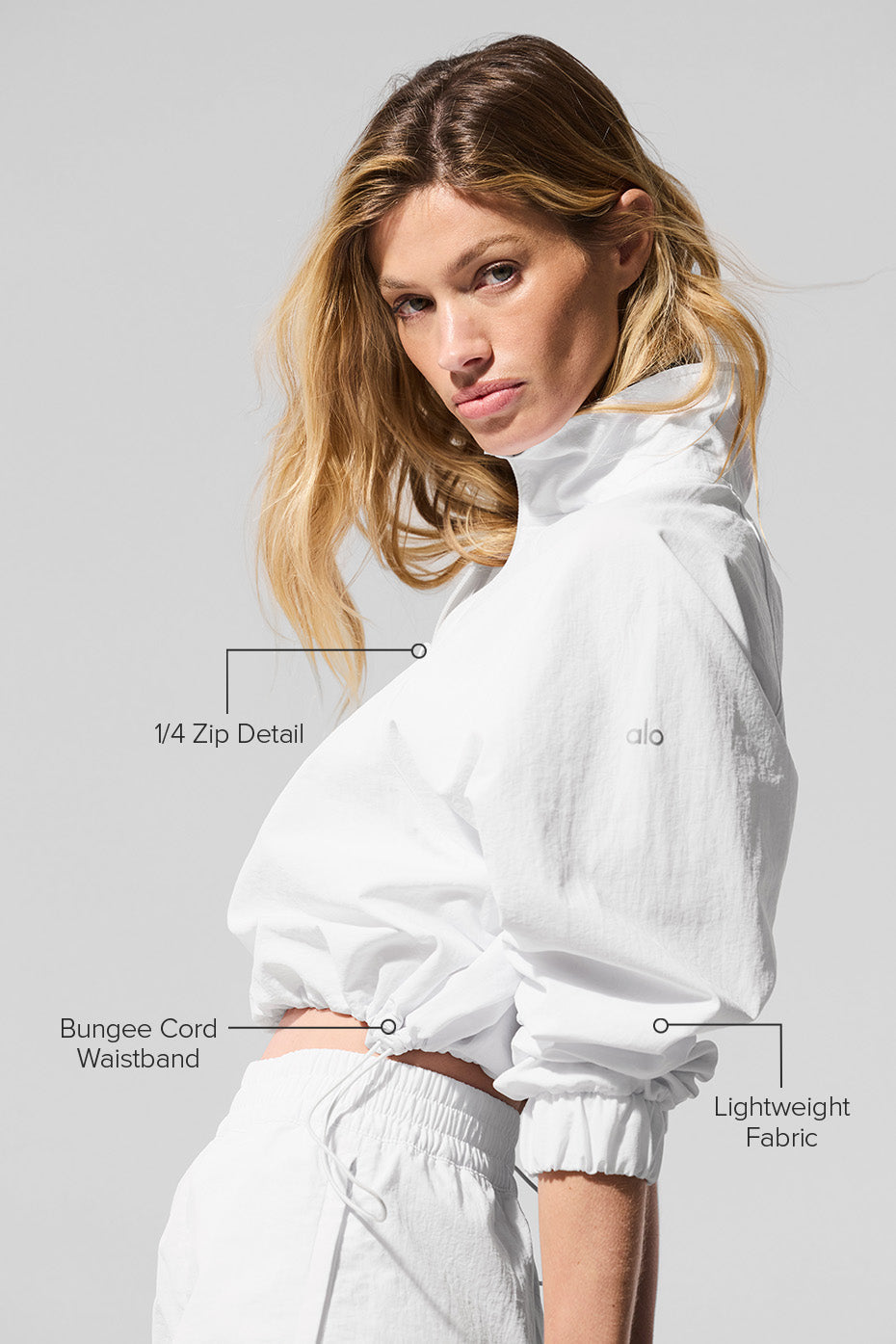 Model wearing the cropped pullover paired with leggings for a sporty look
