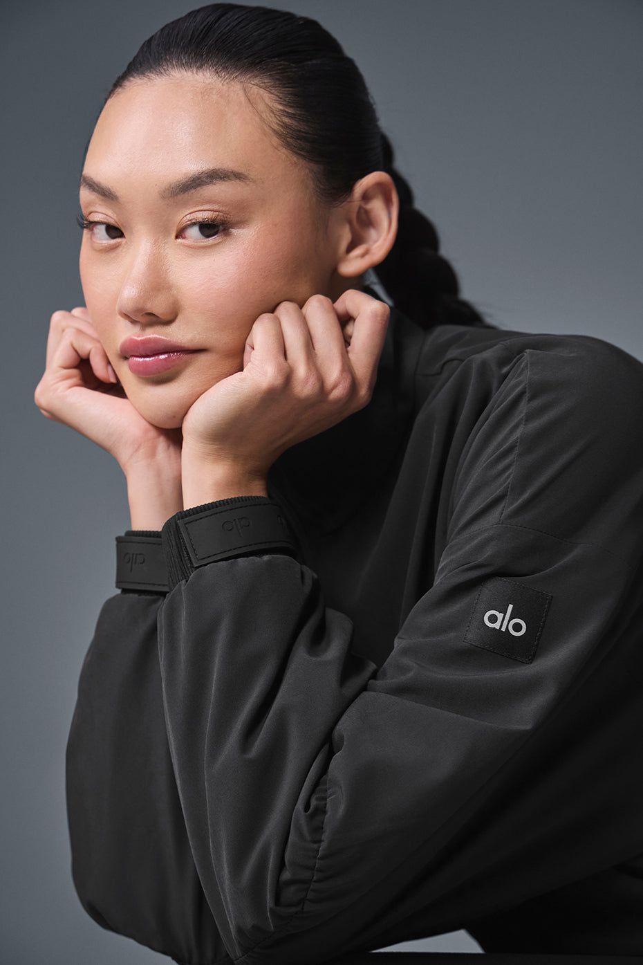 Model showcasing the cropped leather jacket with adjustable bungee detail.