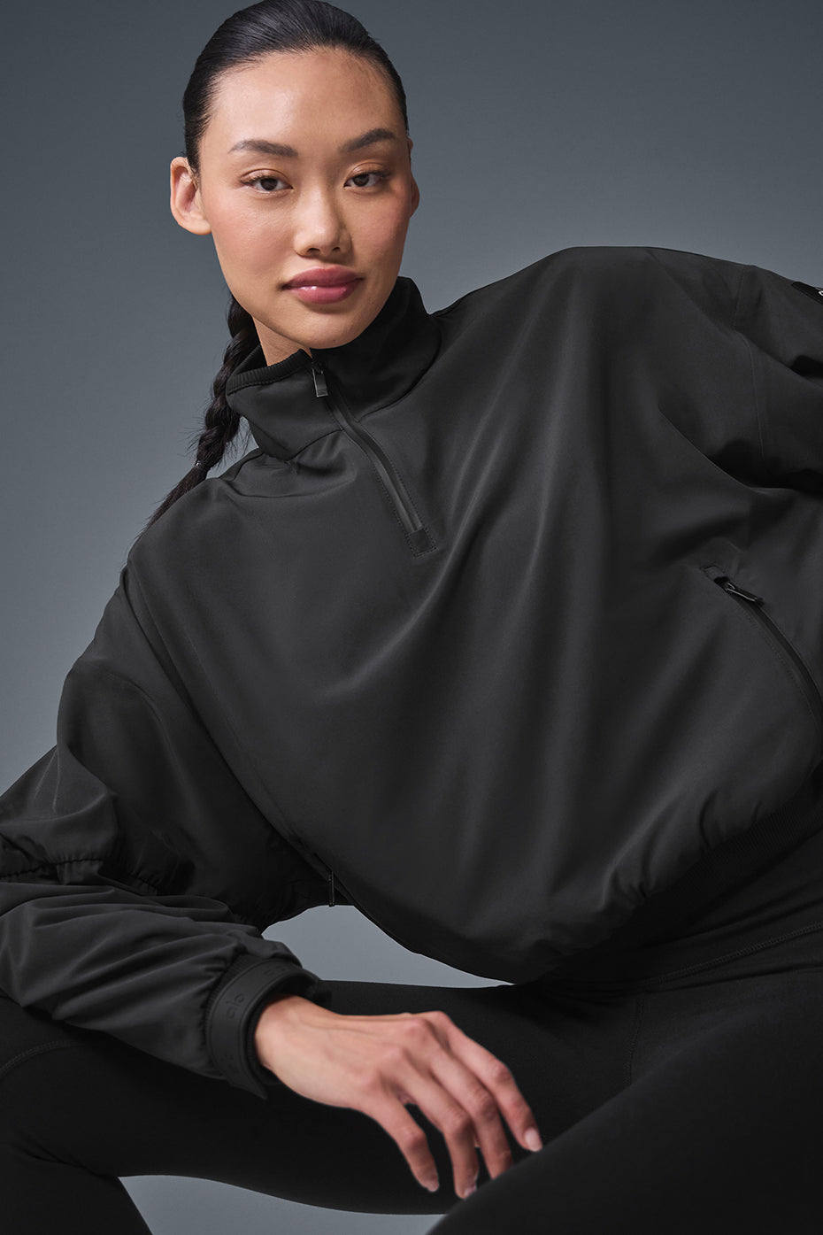 Back view highlighting the ruched details of the cropped bomber jacket.