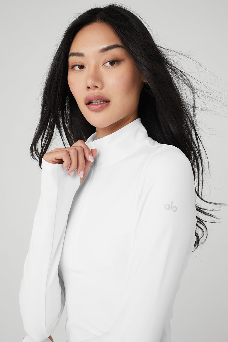 Side profile highlighting invisible zip pocket and sleek seams of performance pullover