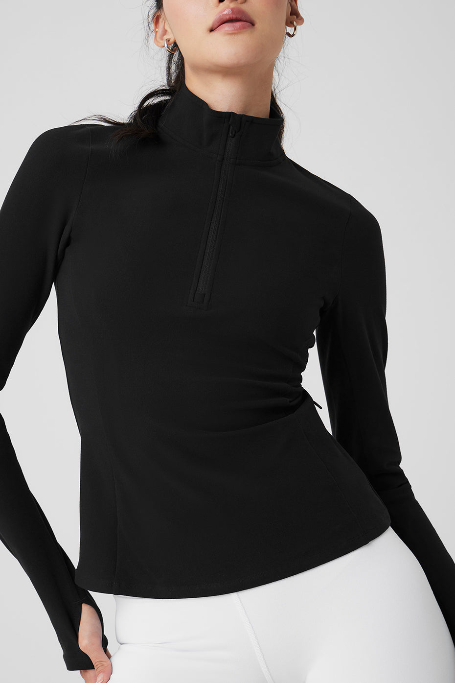 Side angle displaying invisible zip pockets and elevated seams on performance clothing