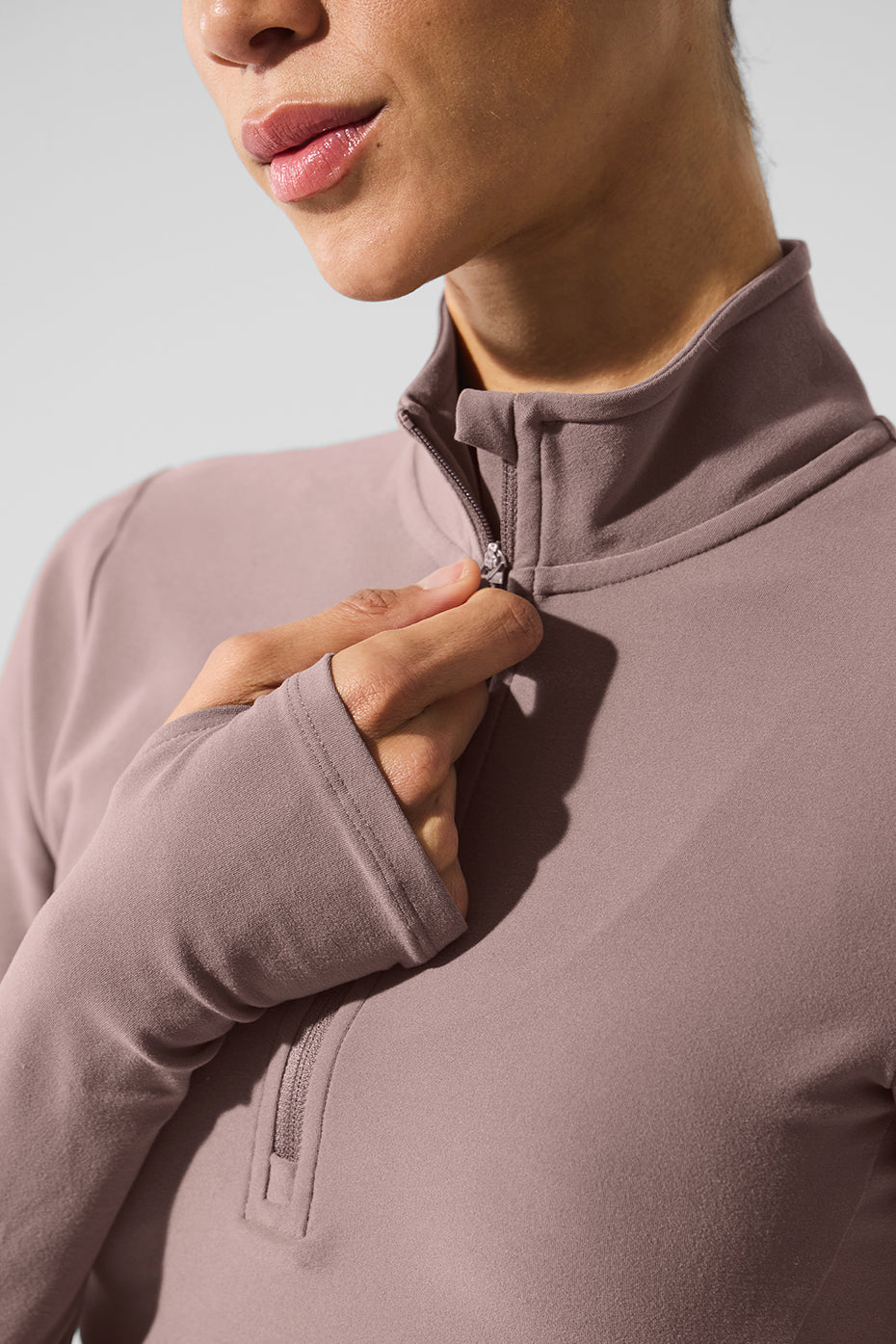 Woman stretching in mushroom pullover and yoga tops