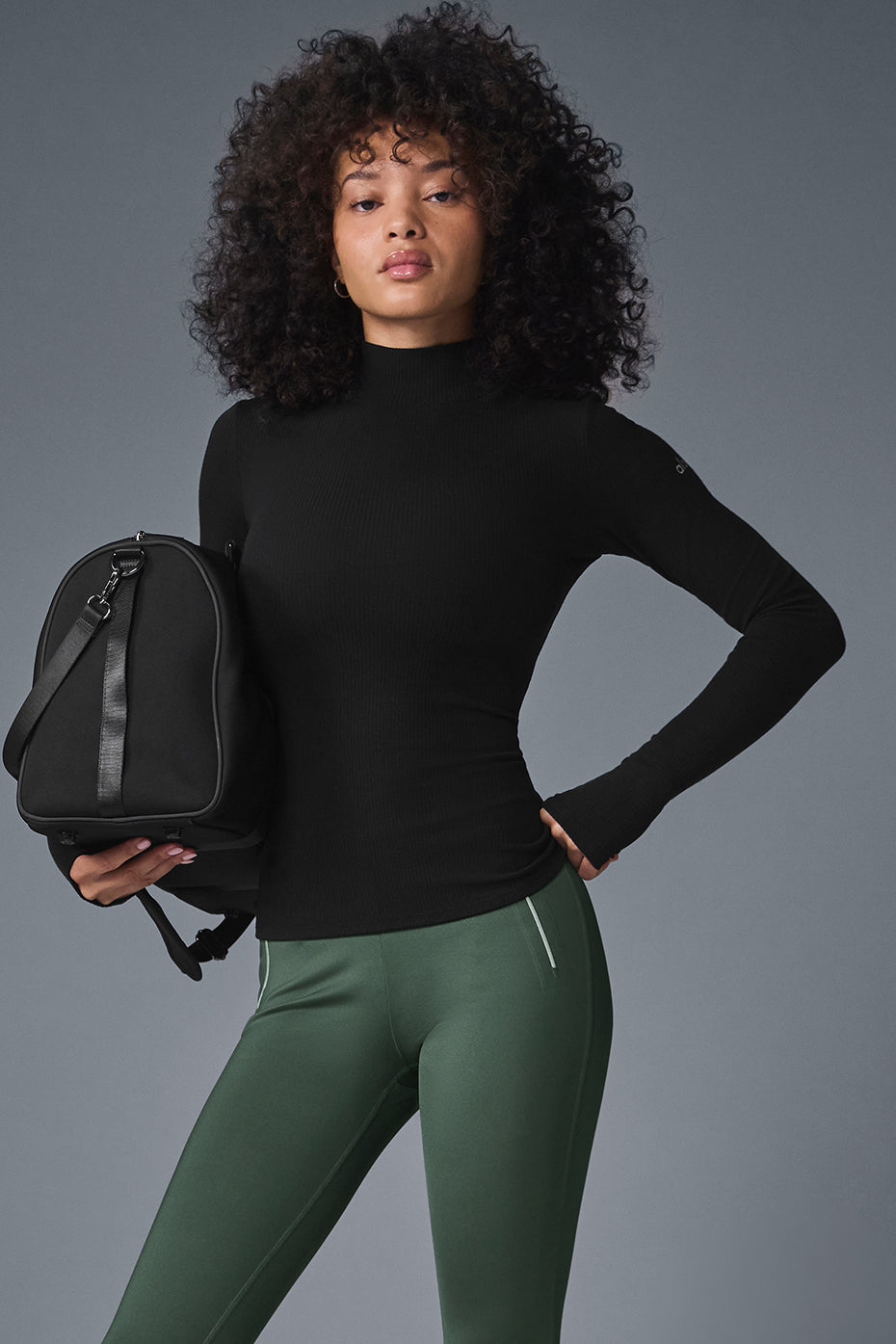 Front view of the black mock neck long sleeve top, showcasing its ribbed fabric.