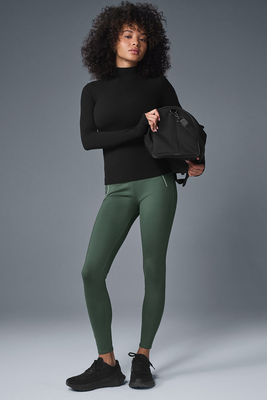 Front view of the black mock neck long sleeve top, showcasing its ribbed fabric.