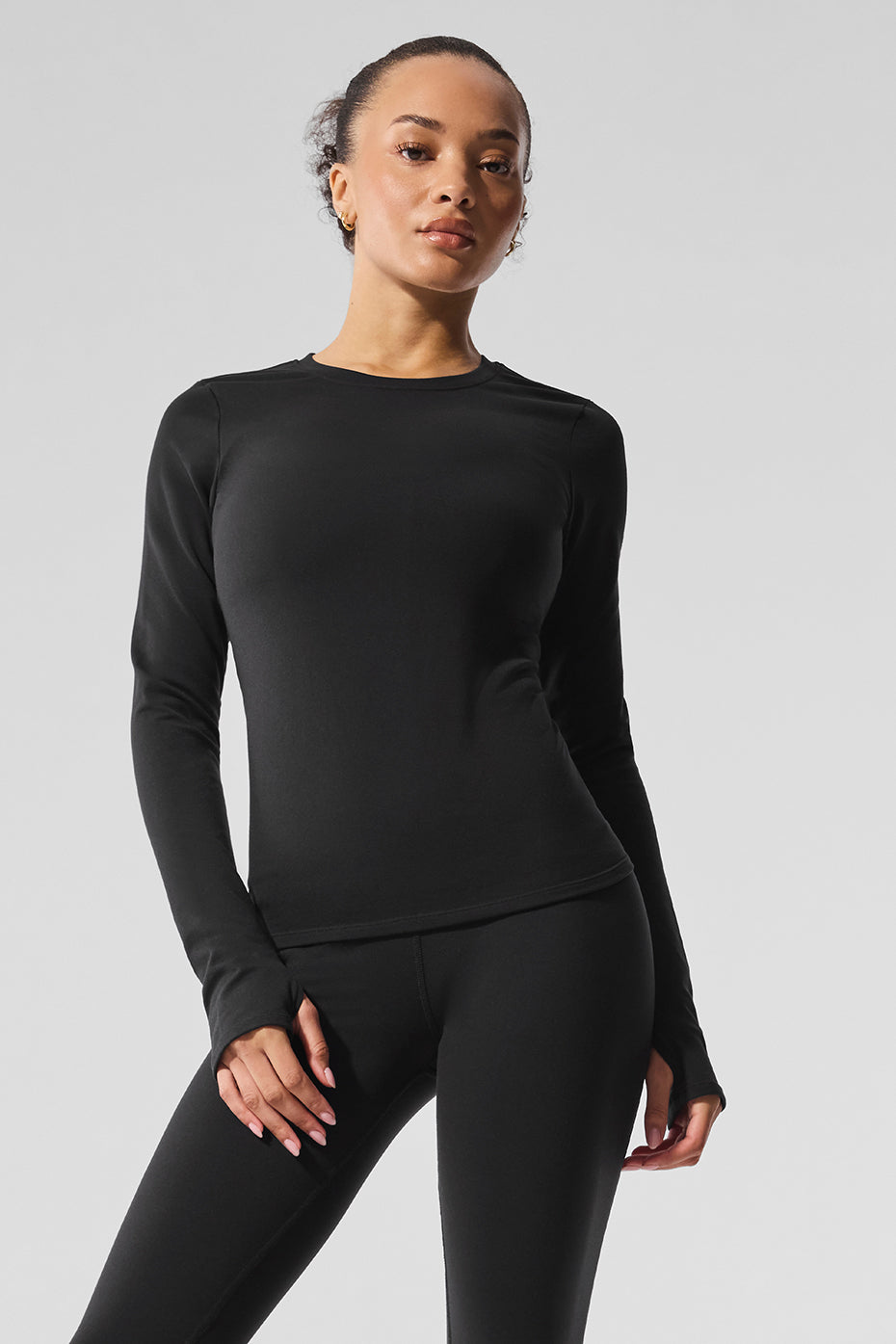 Model wearing the black long sleeve crop top for winter streetwear
