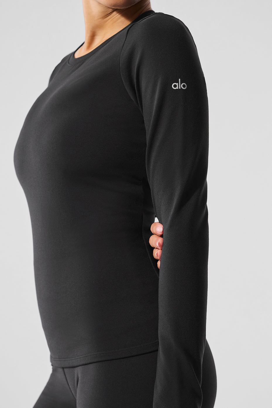Model wearing the black long sleeve crop top for winter streetwear
