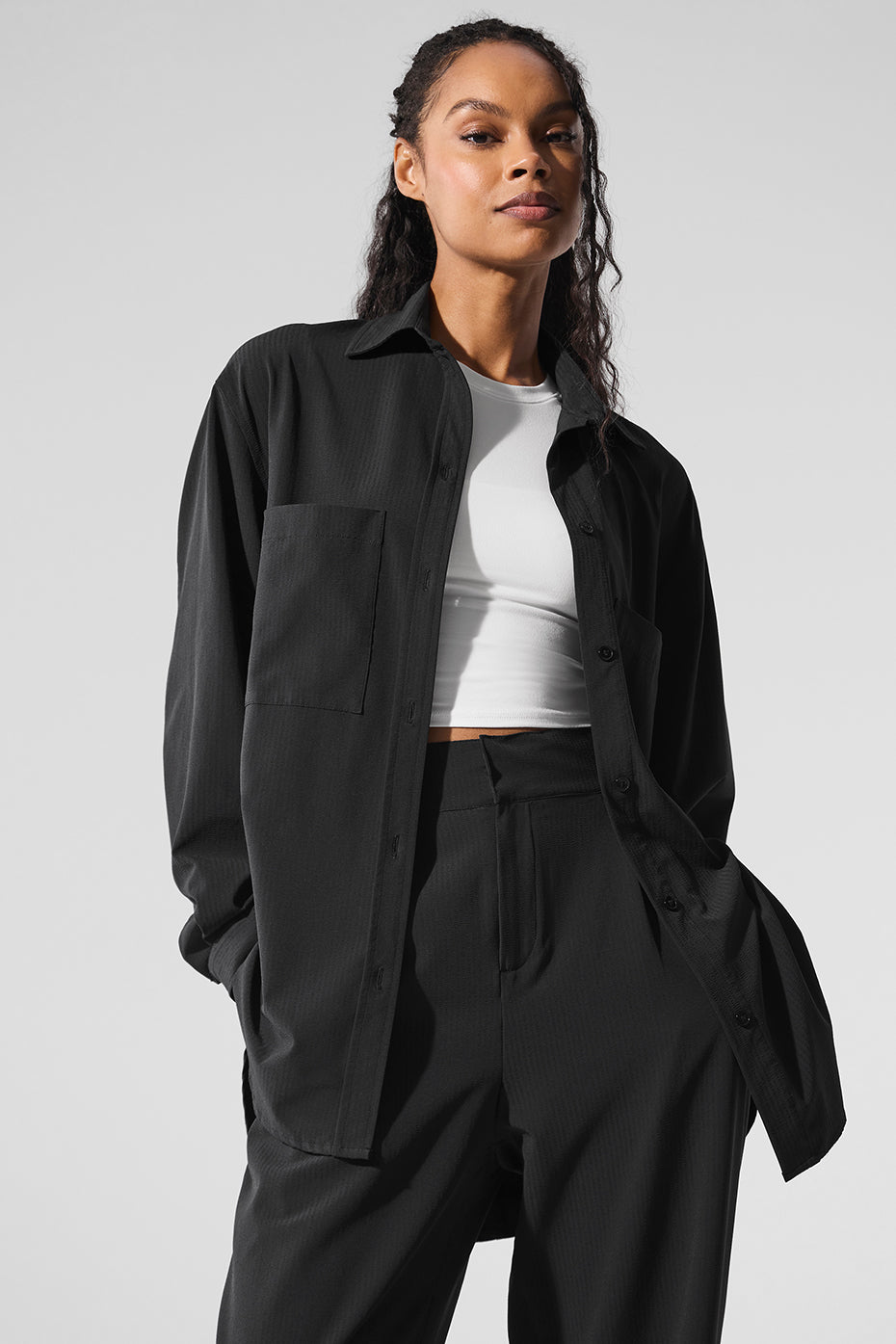 Side angle of the black button-down shirt, highlighting the breathable fabric and pocket detail.