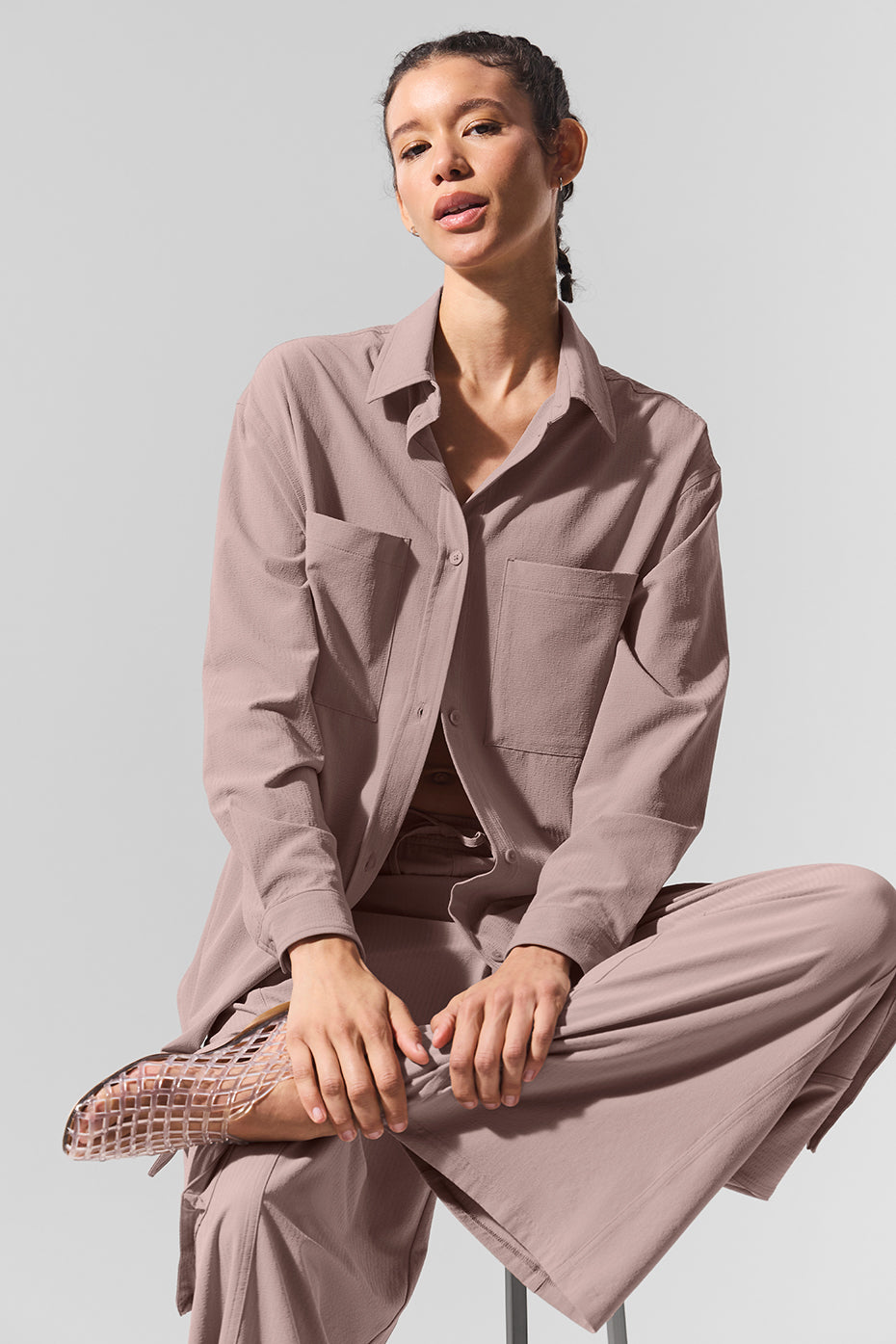 Model pairing the Dreamscape button down shirt with high-waist trousers for a chic look.