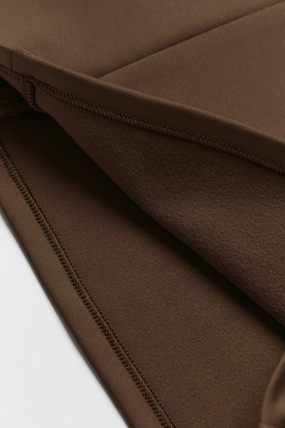 Side view of the insulated hooded running jacket on a runner
