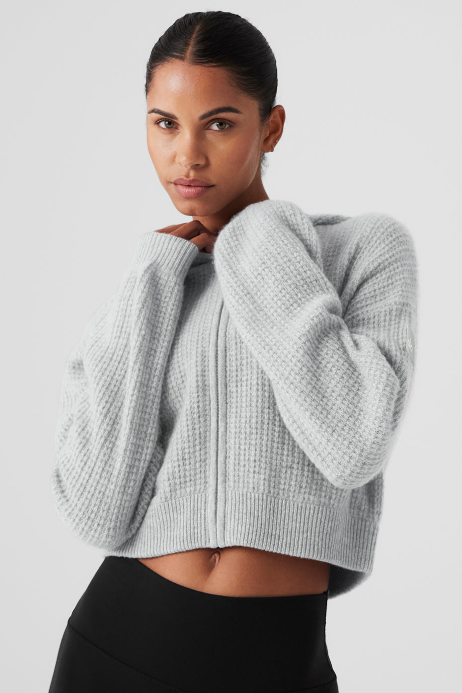 Model wearing a cashmere hoodie women love, styled with high-waist shorts