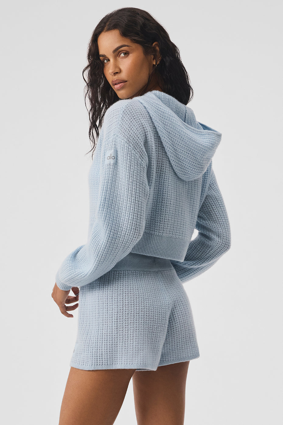 Close-up of cashmere plush waffle texture and full zip hoodie closure