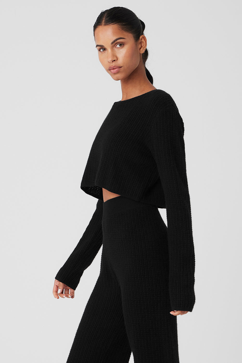 Black waffle knit sweater laid flat to show texture