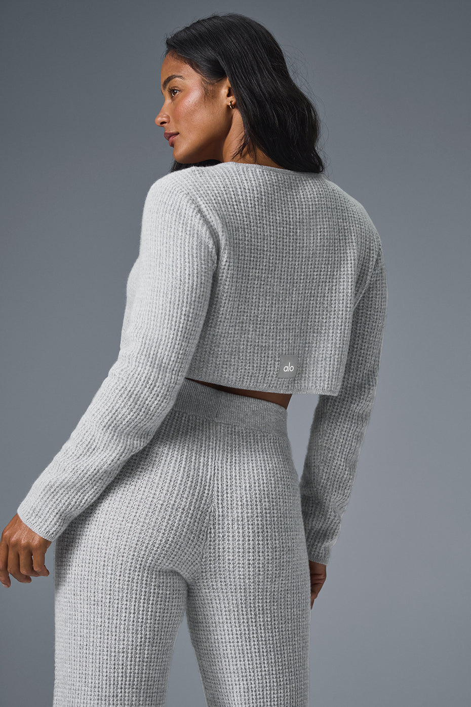 Model wearing mens cashmere sweater during a casual outing, paired with jeans.