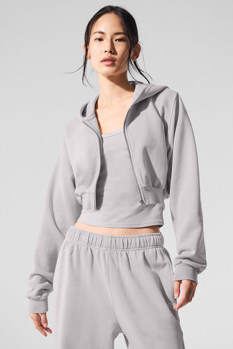 Model wearing a grey colour hoodie with a streamlined fit outdoors