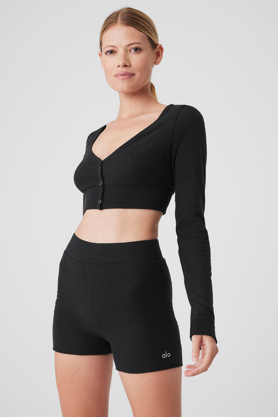 Front view of black cropped cardigan for luxury loungewear.