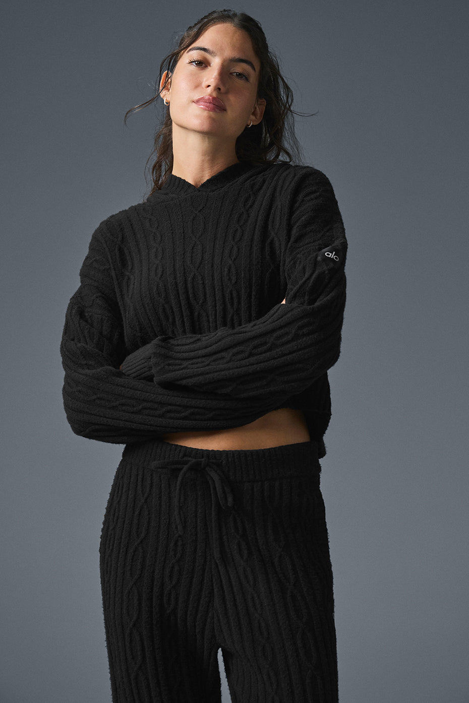 Front view of the cozy cable knit hoodie, showcasing its relaxed fit.