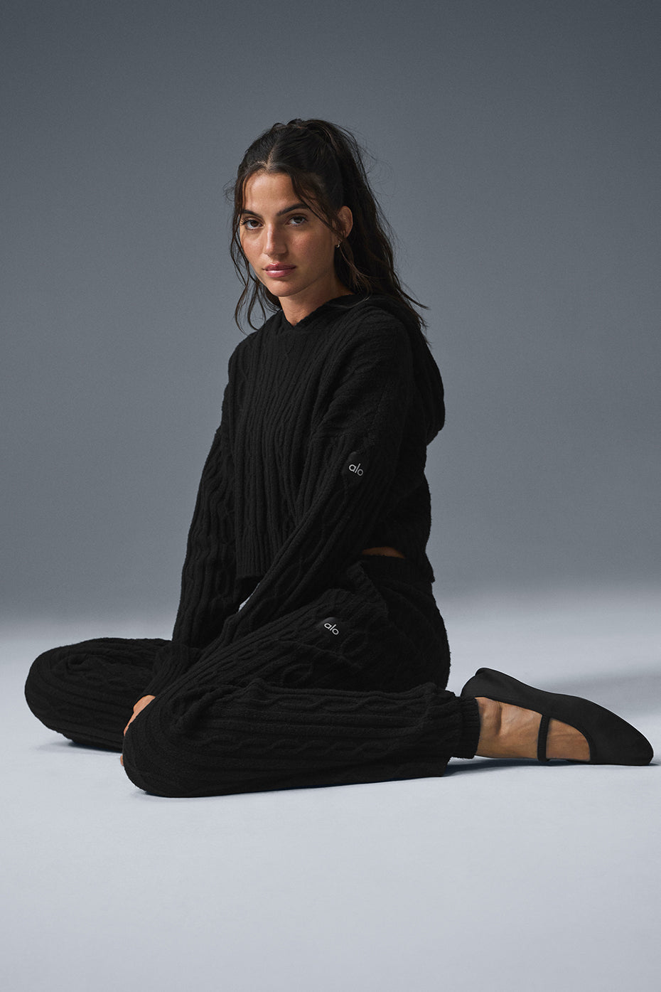 Front view of the cozy cable knit hoodie, showcasing its relaxed fit.