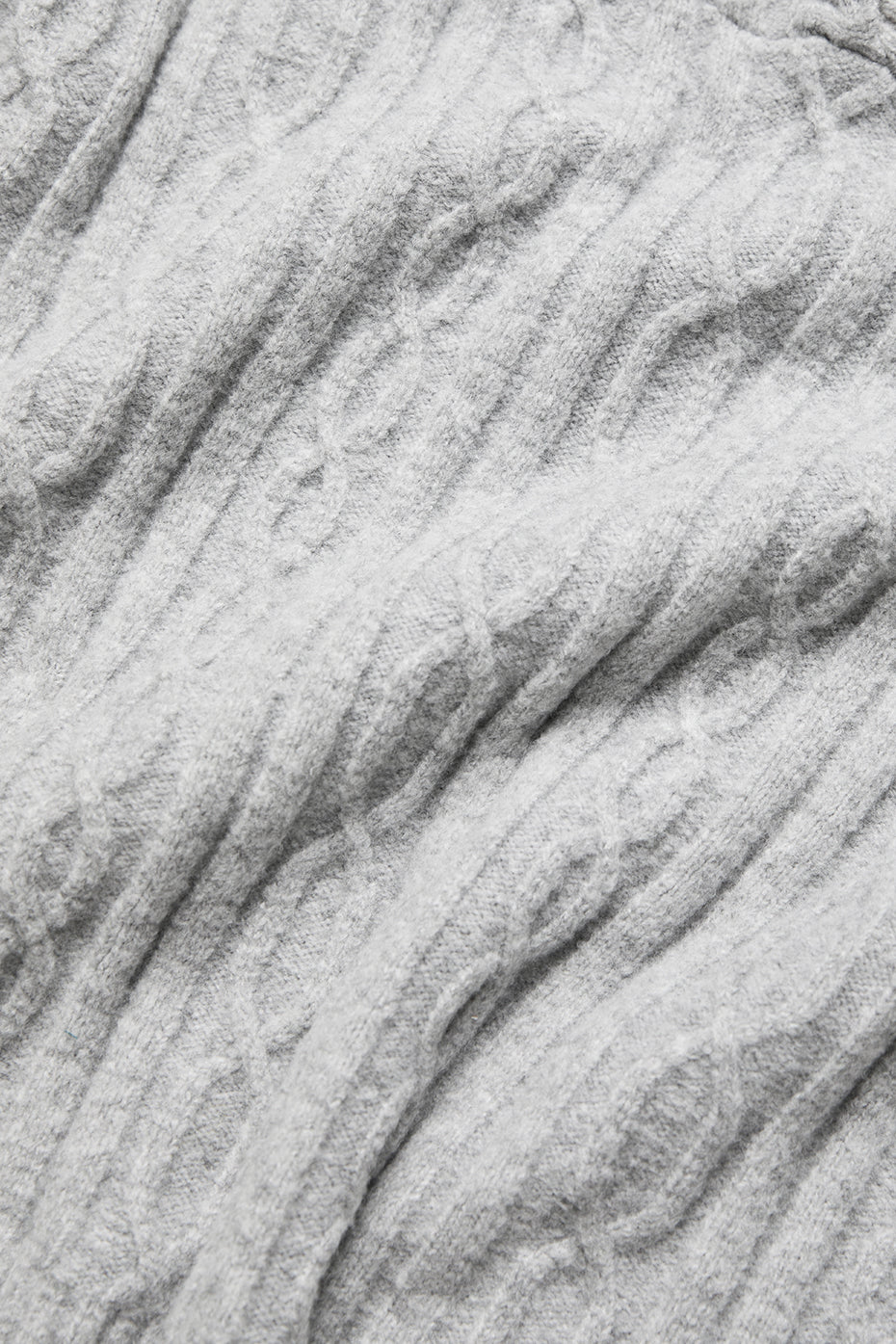 Side view of zip-up hoodie, highlighting relaxed fit and side slits.