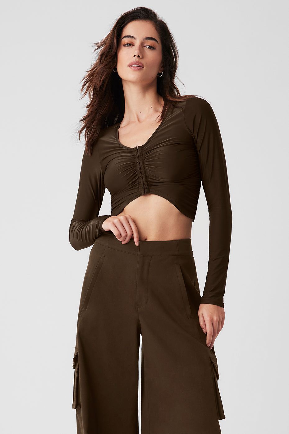 Front view of a sheer long sleeve top with subtle sheen and V-neck detail