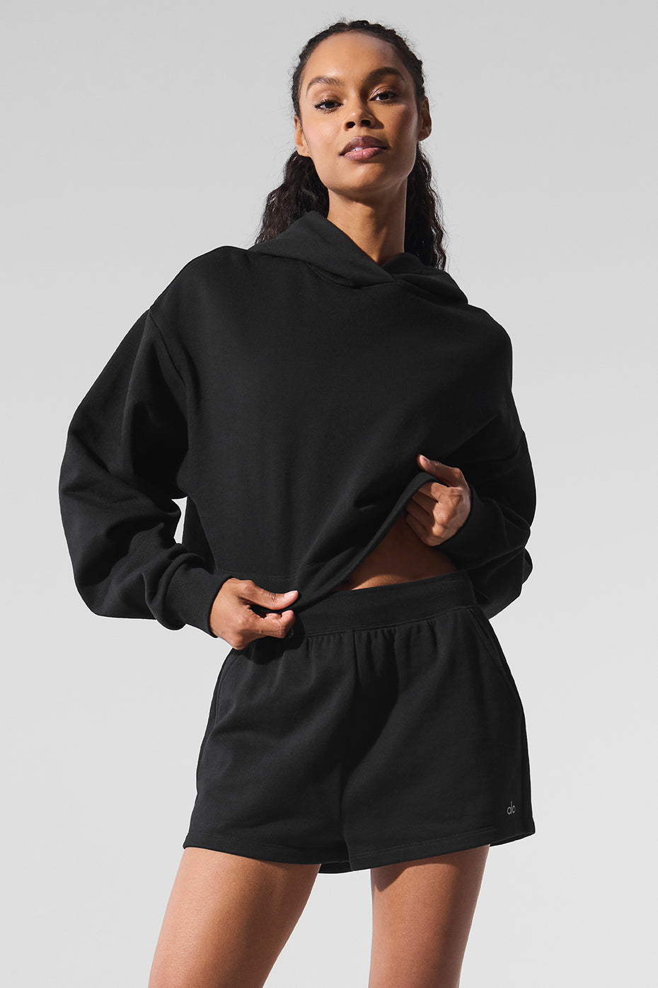 Black comfort hoodie worn with jeans, showcasing relaxed fit.
