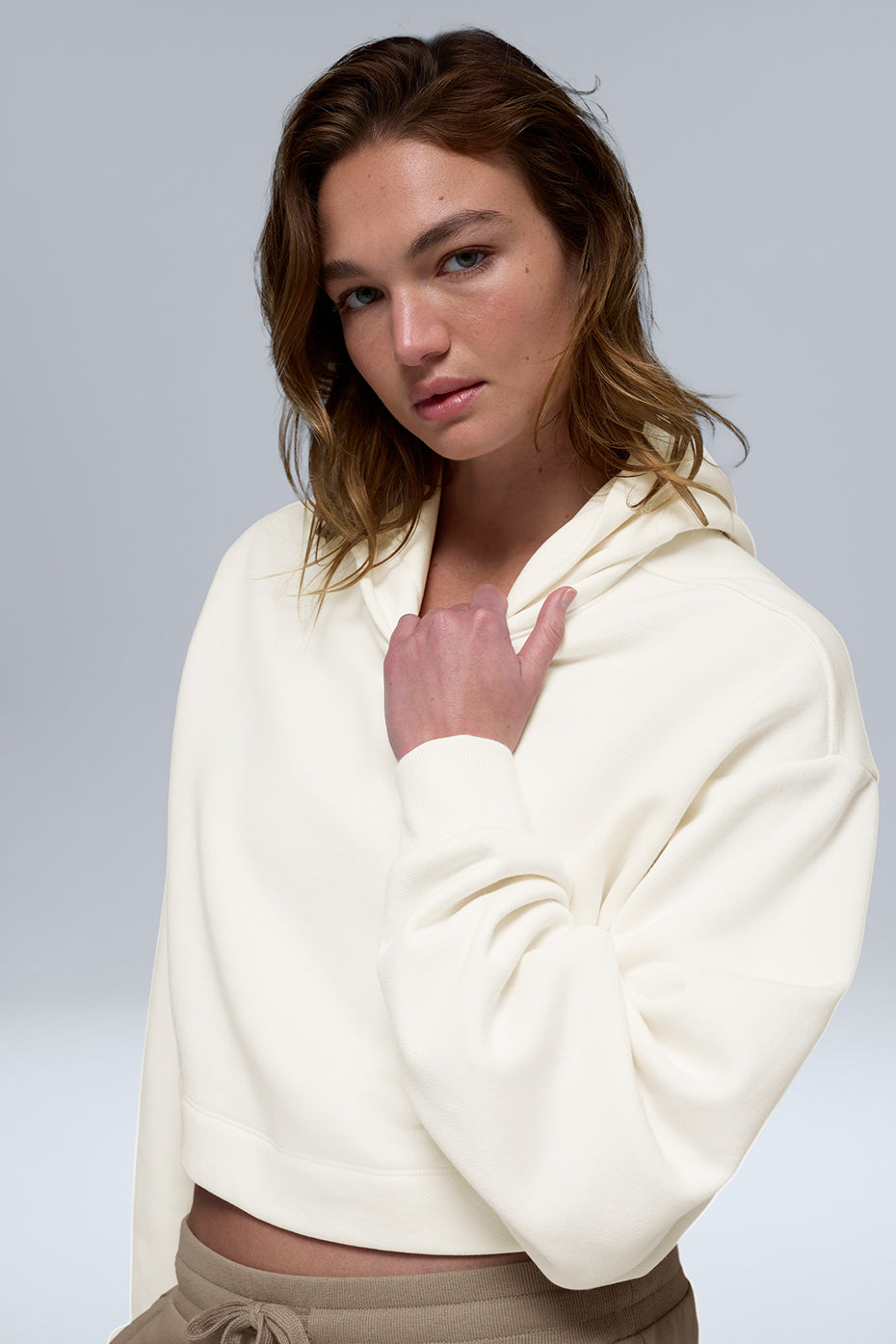 Side angle showing relaxed fit and scrunchable sleeves of the hoodie