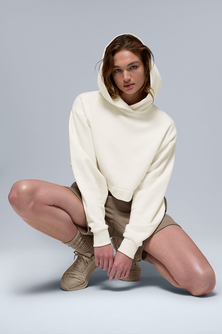 Front view of ivory comfort hoodie with ribbed cuffs and cropped hem