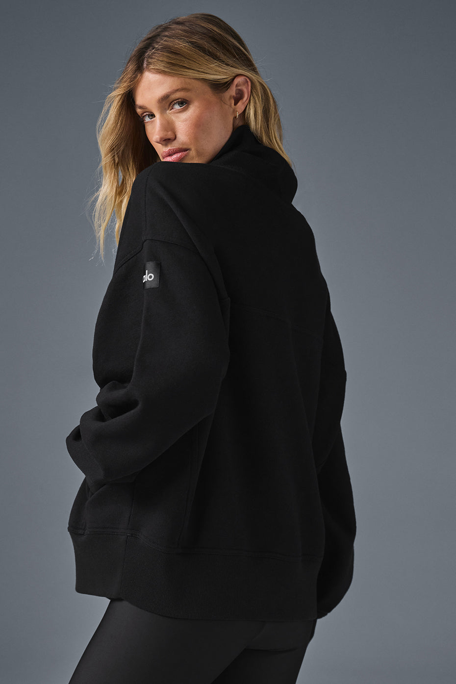 Detail shot of mock neck pullover collar in soft cotton texture.