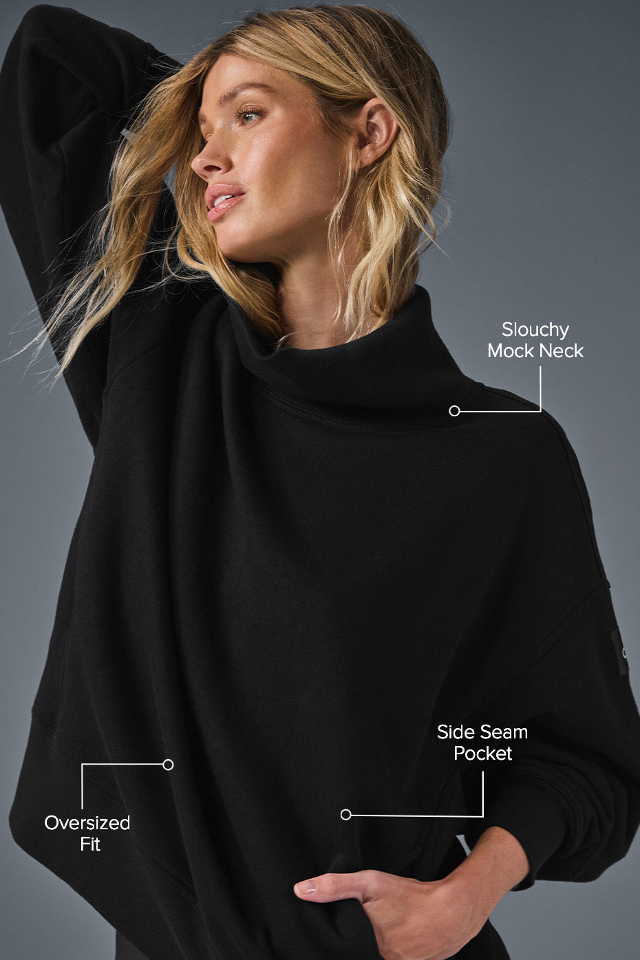 Back view of oversized turtleneck sweater highlighting relaxed fit and drape.
