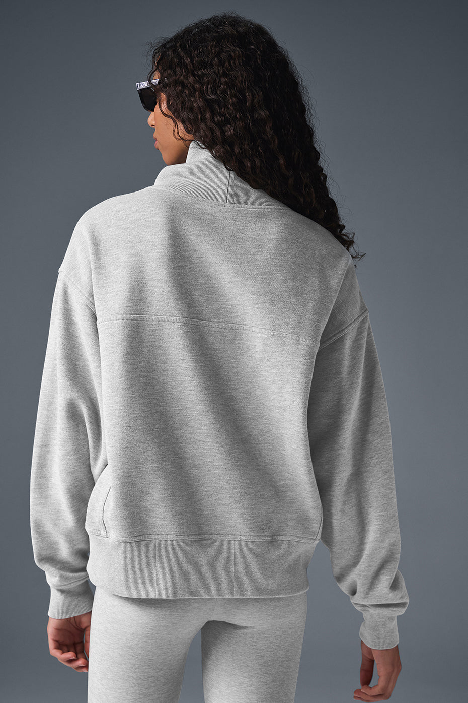 Oversized cardigan sweater folded on rustic bedroom bench