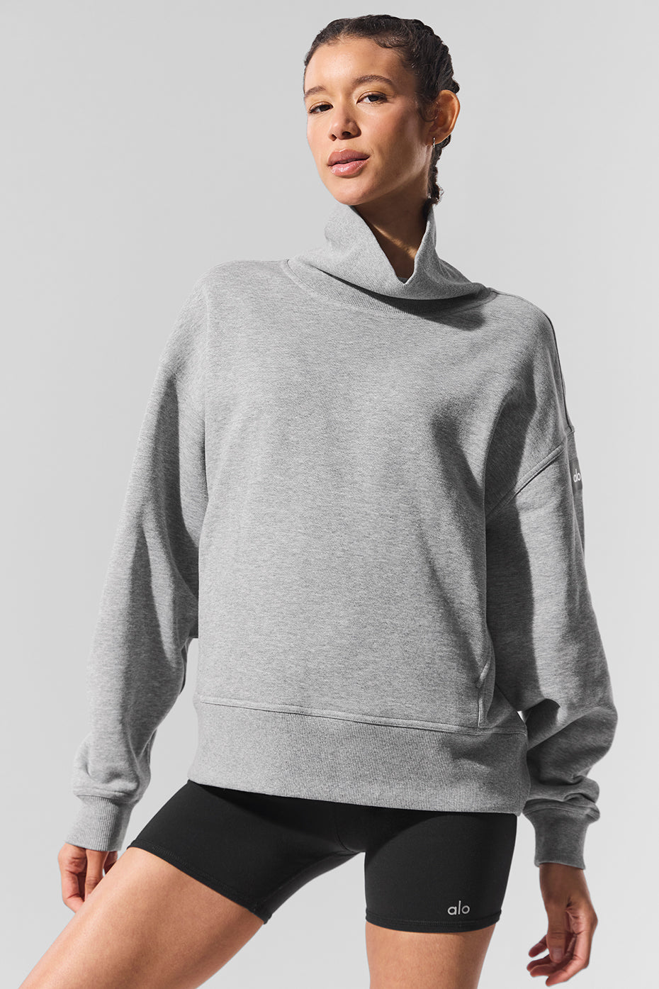 Front view of pullover styled with cargo pants for casual day wear