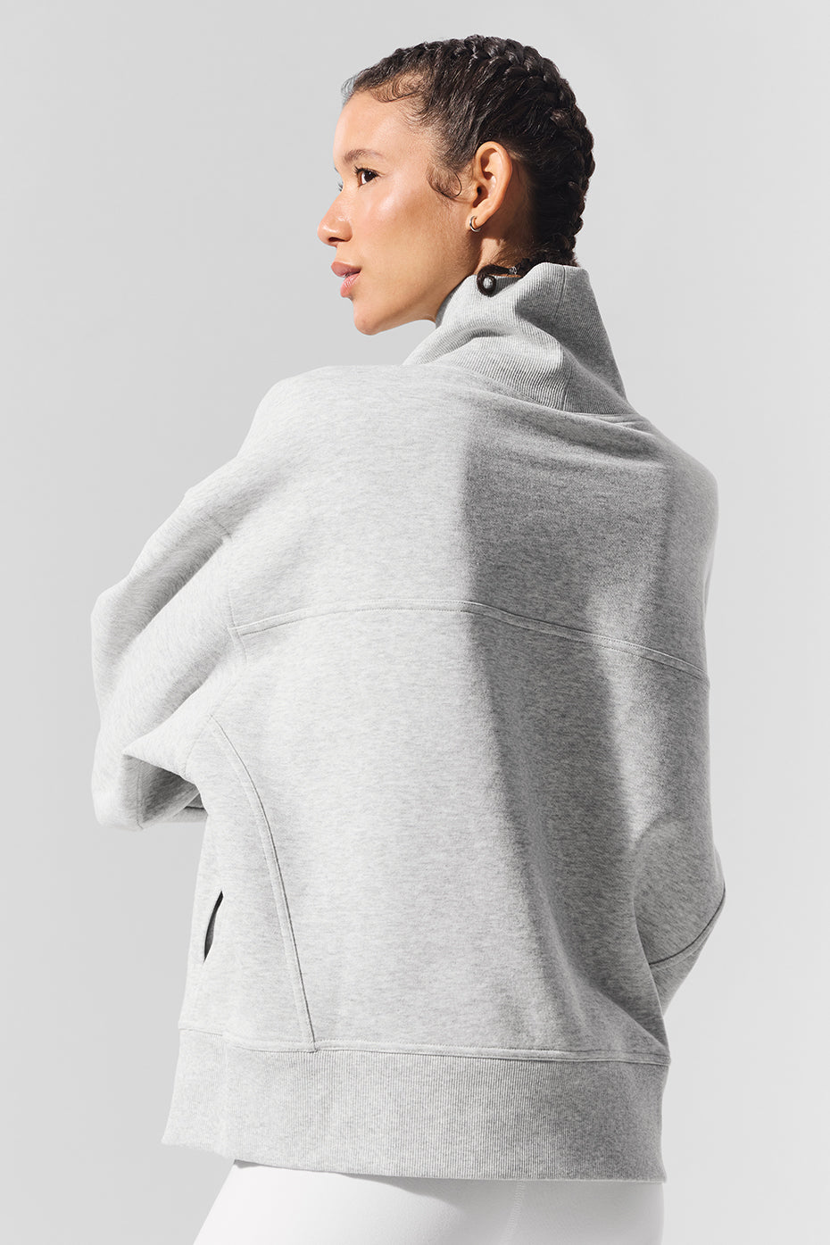 Model lounging in oversized off the shoulder sweater, highlighting its versatility
