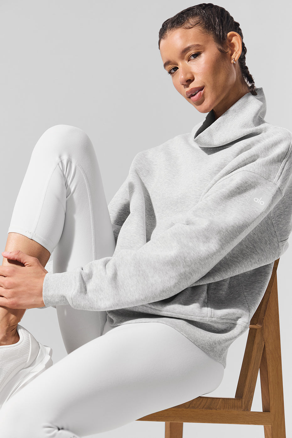 Front view of oversized mock neck sweatshirt in light athletic heather grey, styled with jeans
