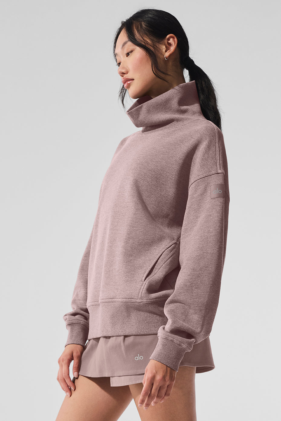 Front view of oversized mushroom heather pullover styled with cargo pants