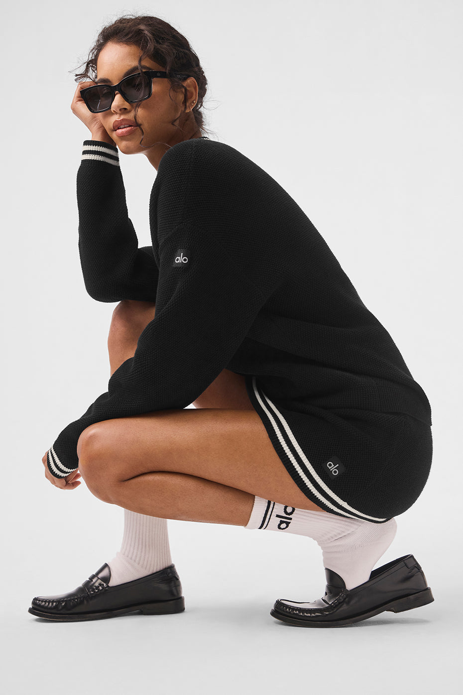 Front view of the black and ivory tennis cardigan on a model.