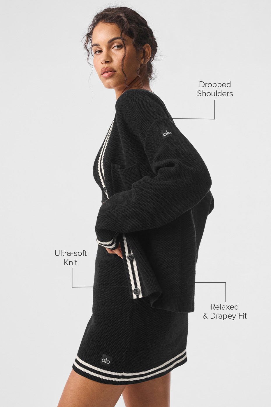 Close-up of the chunky knit texture and button details of the cardigan.